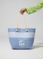 Premium sky blue canvas tote bag for women with white nautical stripes, thick cotton rope handles, secure top zipper, and side pockets - ideal for grocery, university, and beach use in Pakistan.