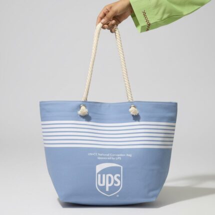 Premium sky blue canvas tote bag for women with white nautical stripes, thick cotton rope handles, secure top zipper, and side pockets - ideal for grocery, university, and beach use in Pakistan.